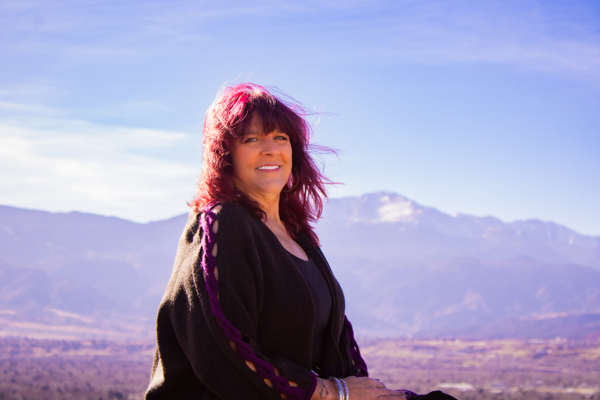 Kara St. Cyr smiling with mountains in the background