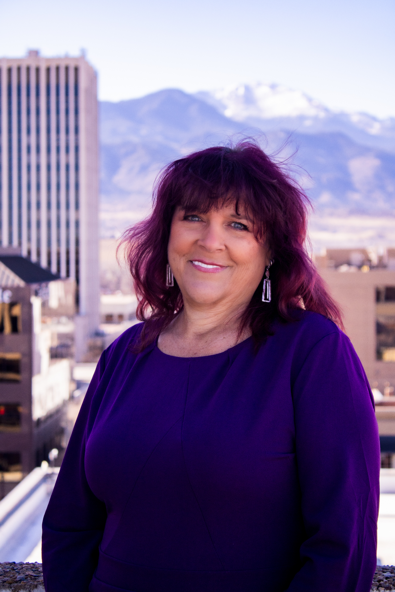 Kara St. Cyr smiling against a Colorado mountain skyline